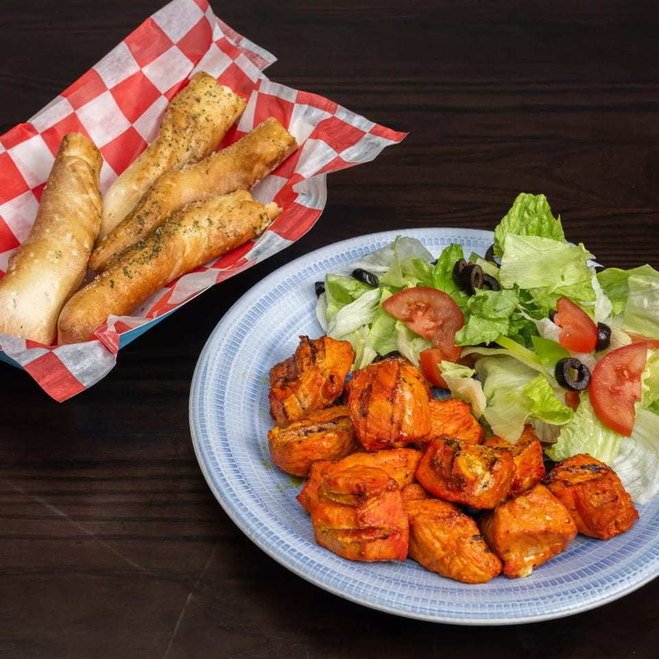 Garlex Pizza & Ribs' chicken tikka with a side salad and garlic breadsticks.
